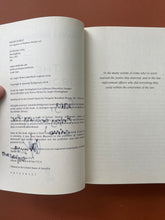 Load image into Gallery viewer, The Subjugate by Amanda Bridgeman: photo of the copyright page which shows the texta that has seeped through the previous page. 

