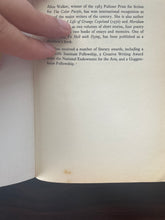 Load image into Gallery viewer, The Temple of My Familiar by Alice Walker book: photo of a blotch of discolouring on the bottom of the first page.
