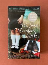 Load image into Gallery viewer, The Time Traveler&#39;s Wife by Audrey Niffenegger: photo of the front cover which shows minor scuff marks along the edges. 
