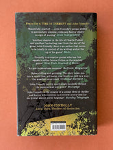 Load image into Gallery viewer, The Woman in the Woods by John Connolly: photo of the back cover which shows very minor (barely visible) scuff marks along the edges of the dust jacket.
