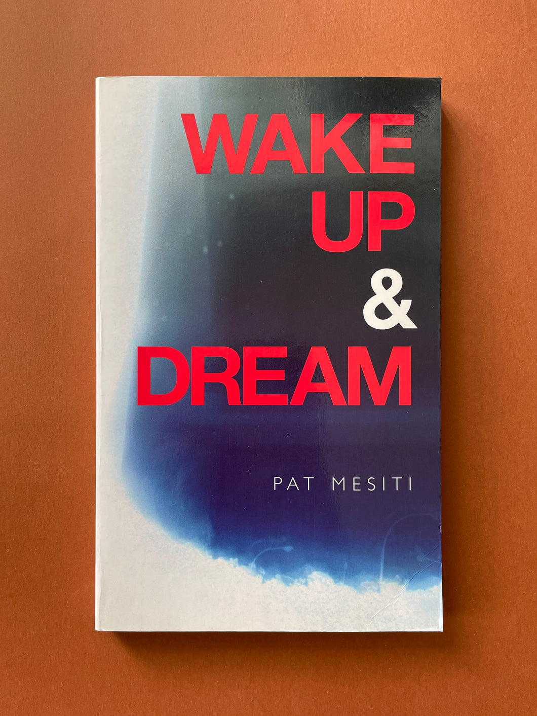 Wake up and Dream by Pat Mesiti: photo of the front cover which shows minor creasing on the bottom-right corner.