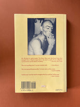 Load image into Gallery viewer, Yul-The Man Who Would Be King by Rock Brynner: photo of the back cover which shows very minor scuff marks and creasing along the edges of the dust jacket, and the remainder of an old price tag, to the right of the barcode.

